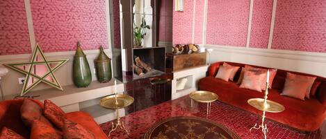 A room with a red sofa, a star-shaped decoration, and a patterned floor.