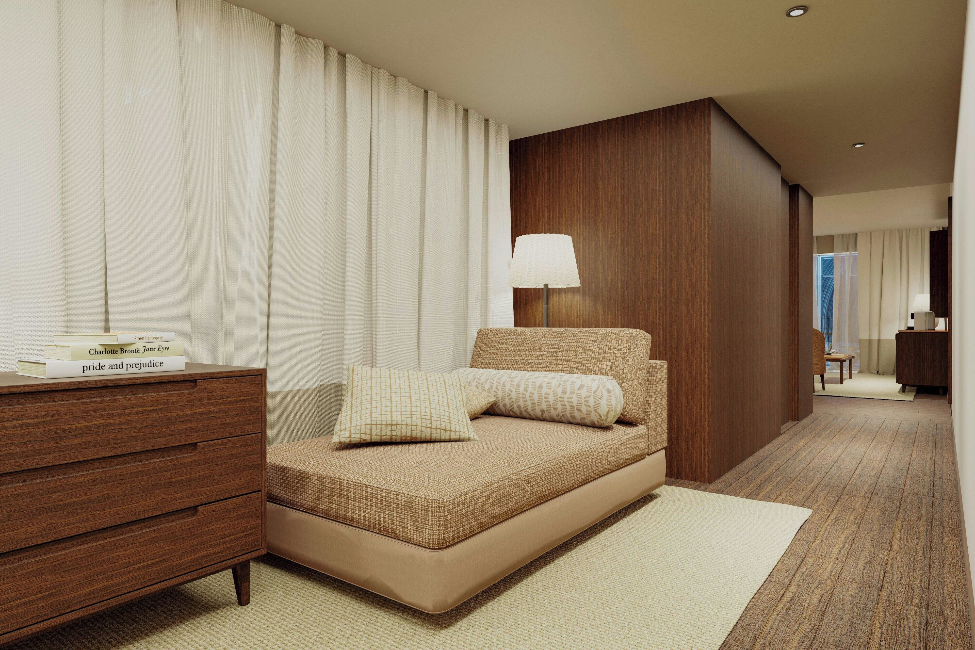 Una habitación de hotel moderna con una cama, una mesita de noche, una lámpara y un armario de madera.
