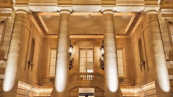 A grand building with large columns, a central staircase, and a symmetrical facade.