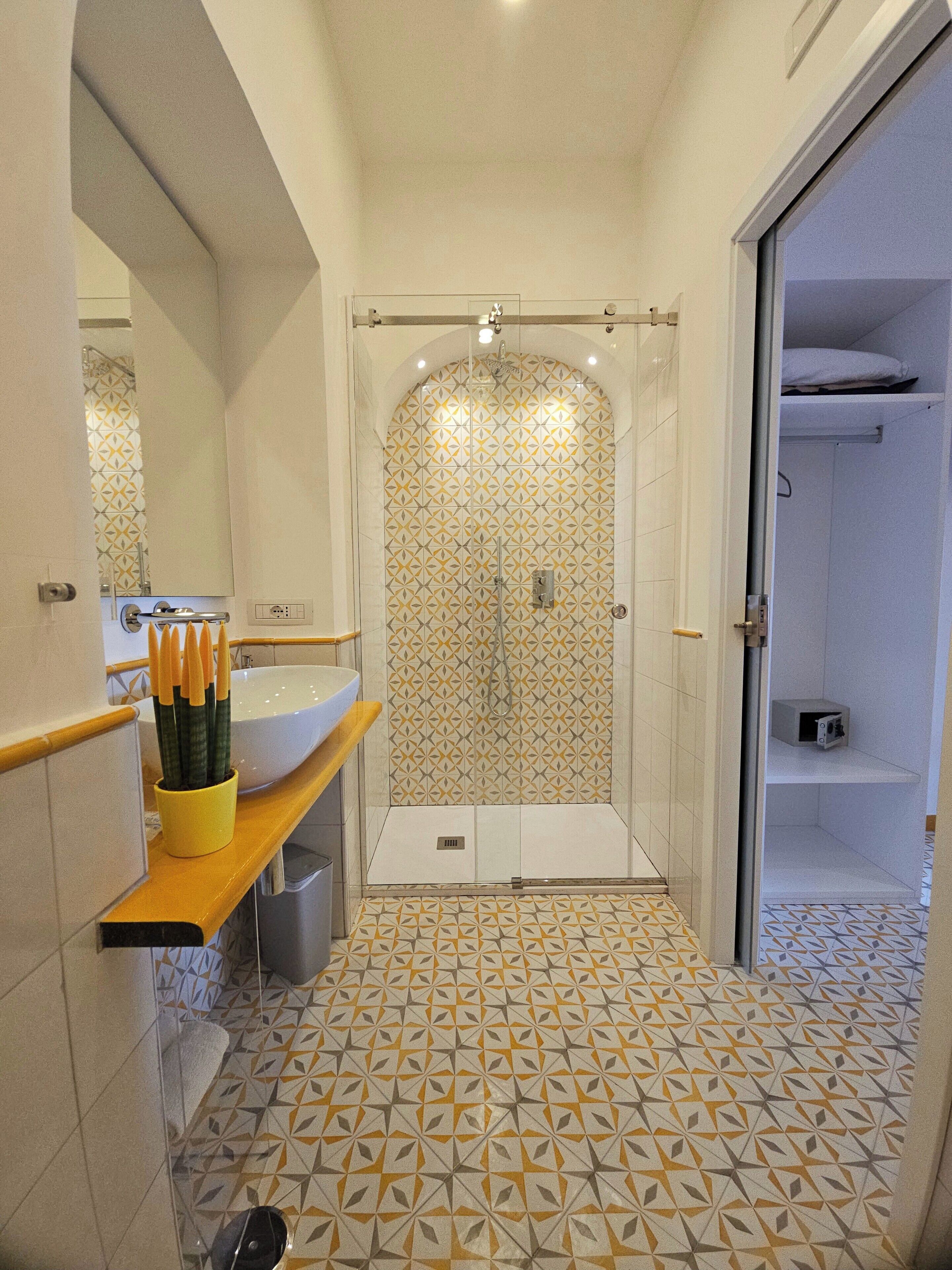 A bathroom with a shower, a sink, and a toilet.