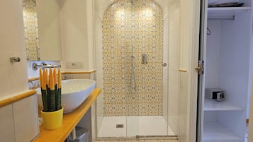 A bathroom with a shower, a sink, and a toilet.