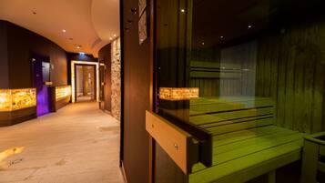 A hallway with a wooden bench, stone walls, and illuminated panels.