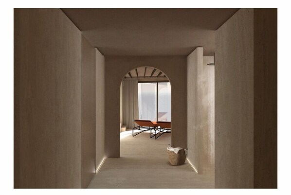 A hallway with a view of a dining area, featuring a table and chairs.