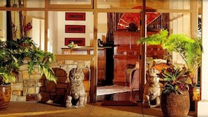 A traditional interior with stone walls, wooden furniture, and potted plants. - Tradewinds Carmel (Carmel)