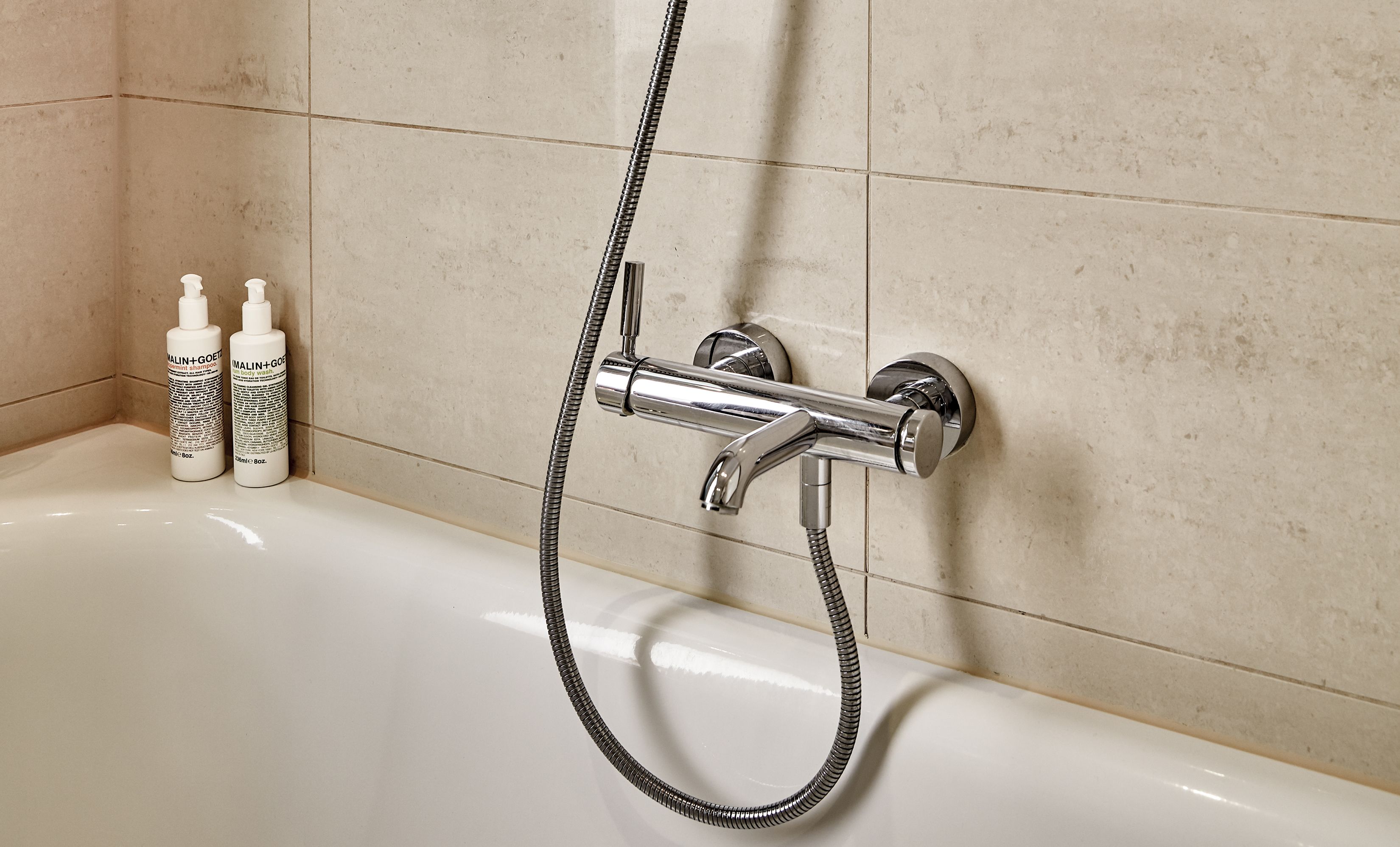 standard double room | bathroom | deep-soaking bathtub, designer toiletries, hair dryer, bathrobes