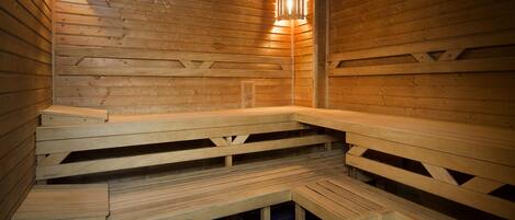 A sauna with wooden benches and a tiled floor.