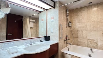 A bathroom with a marble sink, a mirror, a shower, and a bathtub.
