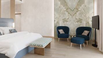 A modern hotel room with a bed, two armchairs, a bench, a TV, and a marble-patterned wall.