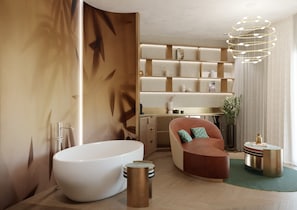 A modern bathroom with a freestanding bathtub, a curved seating area, and a built-in shelving unit with decorative items. - Hotel Val di Sogno (Malcesine)
