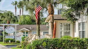 A motel with a sign indicating 'No Vacancy' and an American flag. - The Cozy Inn (St. Augustine)