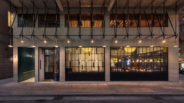 A modern building with large windows and a unique lighting system.
