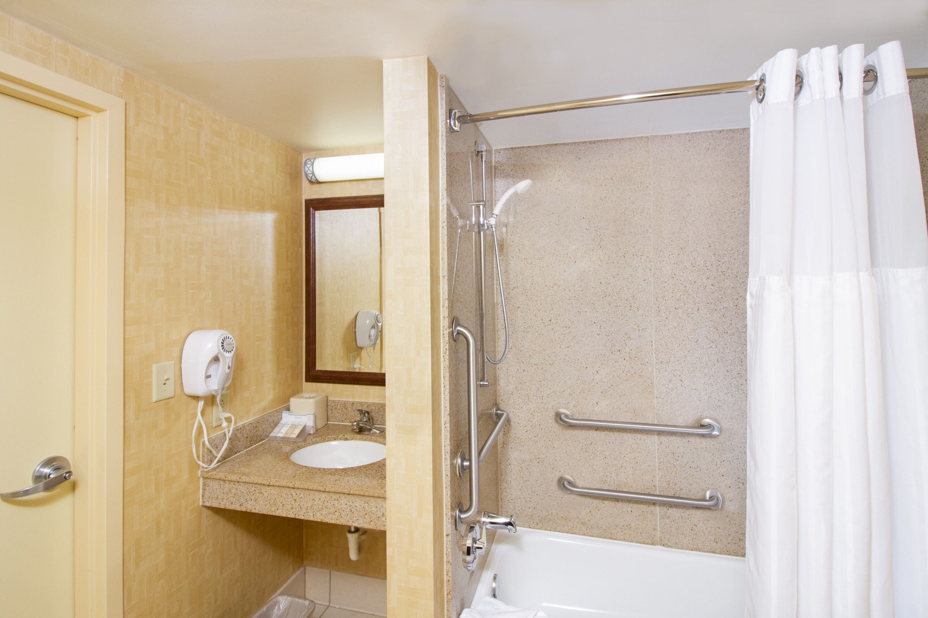 bathtub, hair dryer, towels, soap