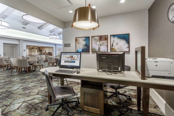 A modern office space with a large desk, computer, printer, and comfortable seating. - Homewood Suites by Hilton Albany (Albany)