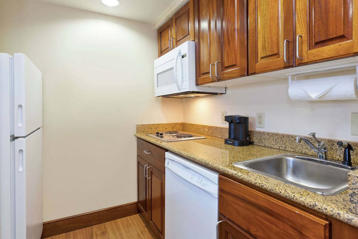 one bedroom suite, two queen beds, non-smoking | private kitchen | full-sized fridge, microwave, stovetop, dishwasher