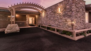 A stone building with a sign labeled "OFFICE" and a covered entrance. - Little Sur Inn (Cambria)