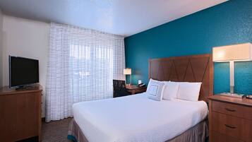 Premium bedding, desk, laptop workspace, blackout curtains