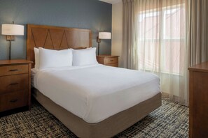 A hotel room with a large bed, two bedside tables, a nightstand, a lamp, and a window with sheer curtains. - Residence Inn by Marriott Columbia (Columbia)