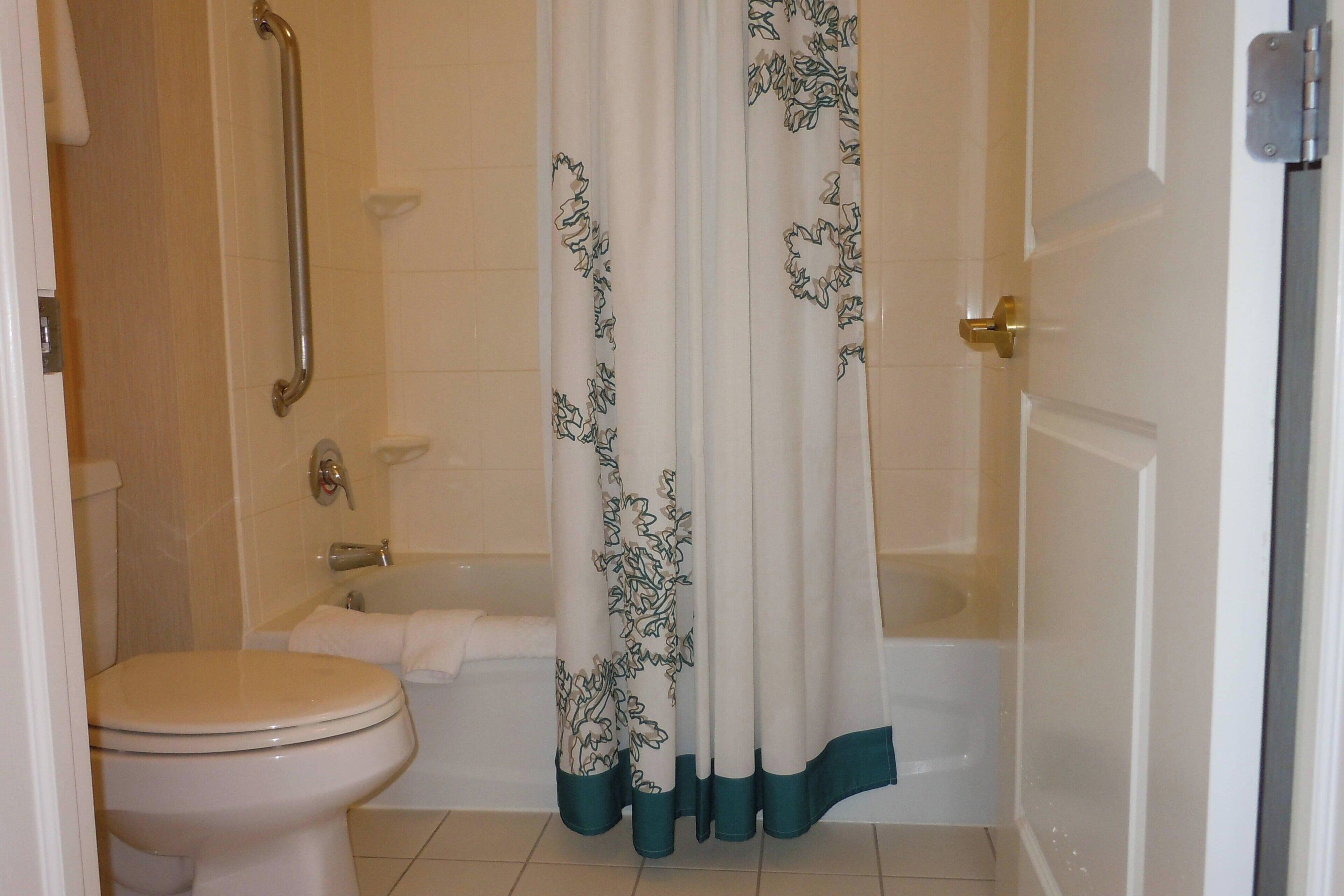 combined shower/bathtub, designer toiletries, hair dryer, towels