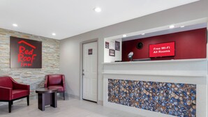A reception area with a Red Roof Inn sign, a 'Free Wi-Fi All Rooms' sign, and a 'Manager on Duty' sign. - Red Roof Inn Hope (Hope)