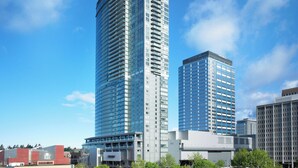 A modern high-rise building with a glass facade, surrounded by other buildings and trees. - The Westin Bellevue (Bellevue)