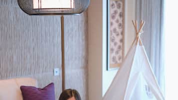 Relax in a warm and inviting space with a comfortable sofa and a playful teepee tent.