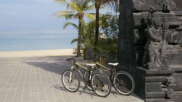A beachside location with bicycles parked near a stone structure.