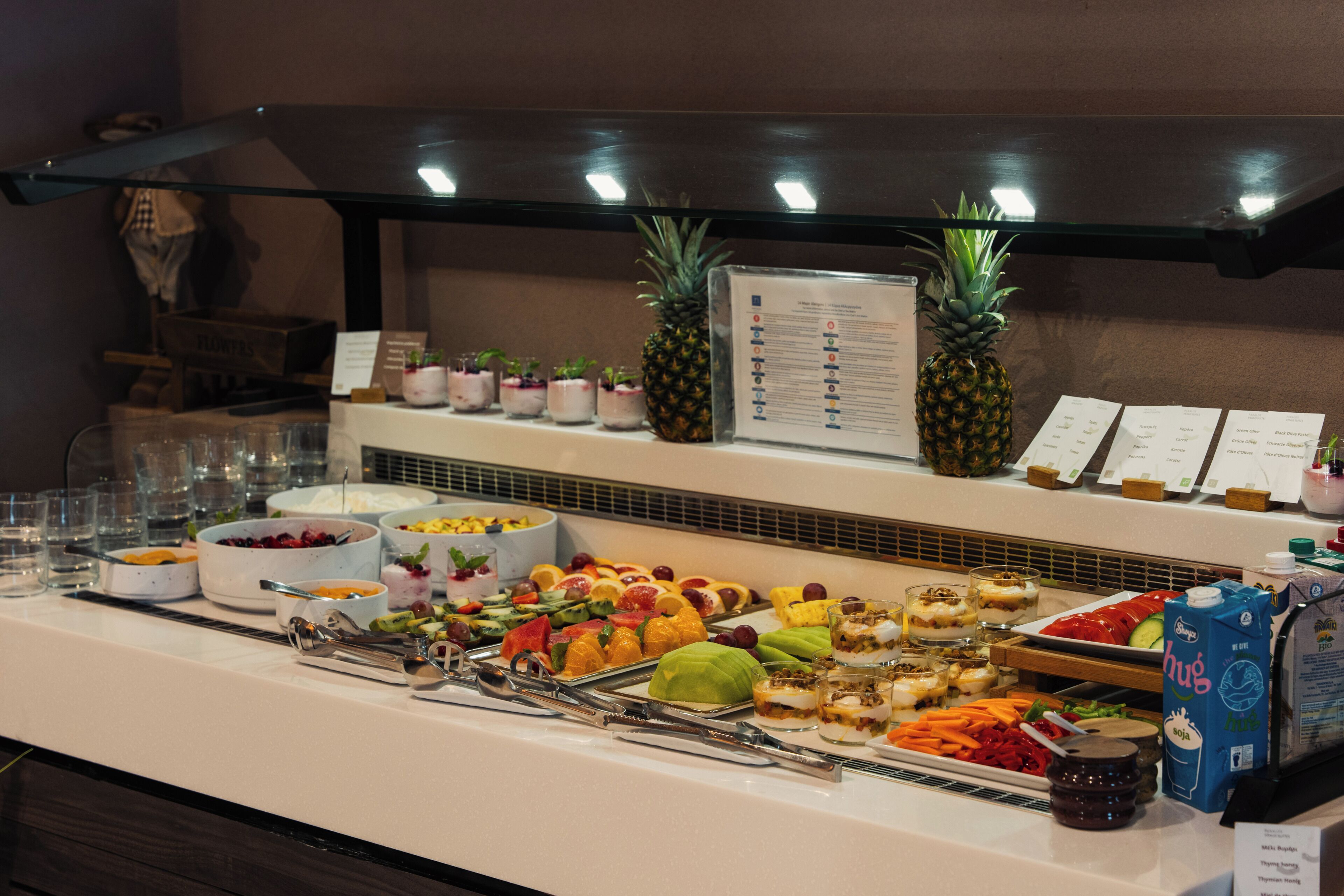 A buffet with various food items and a menu board.