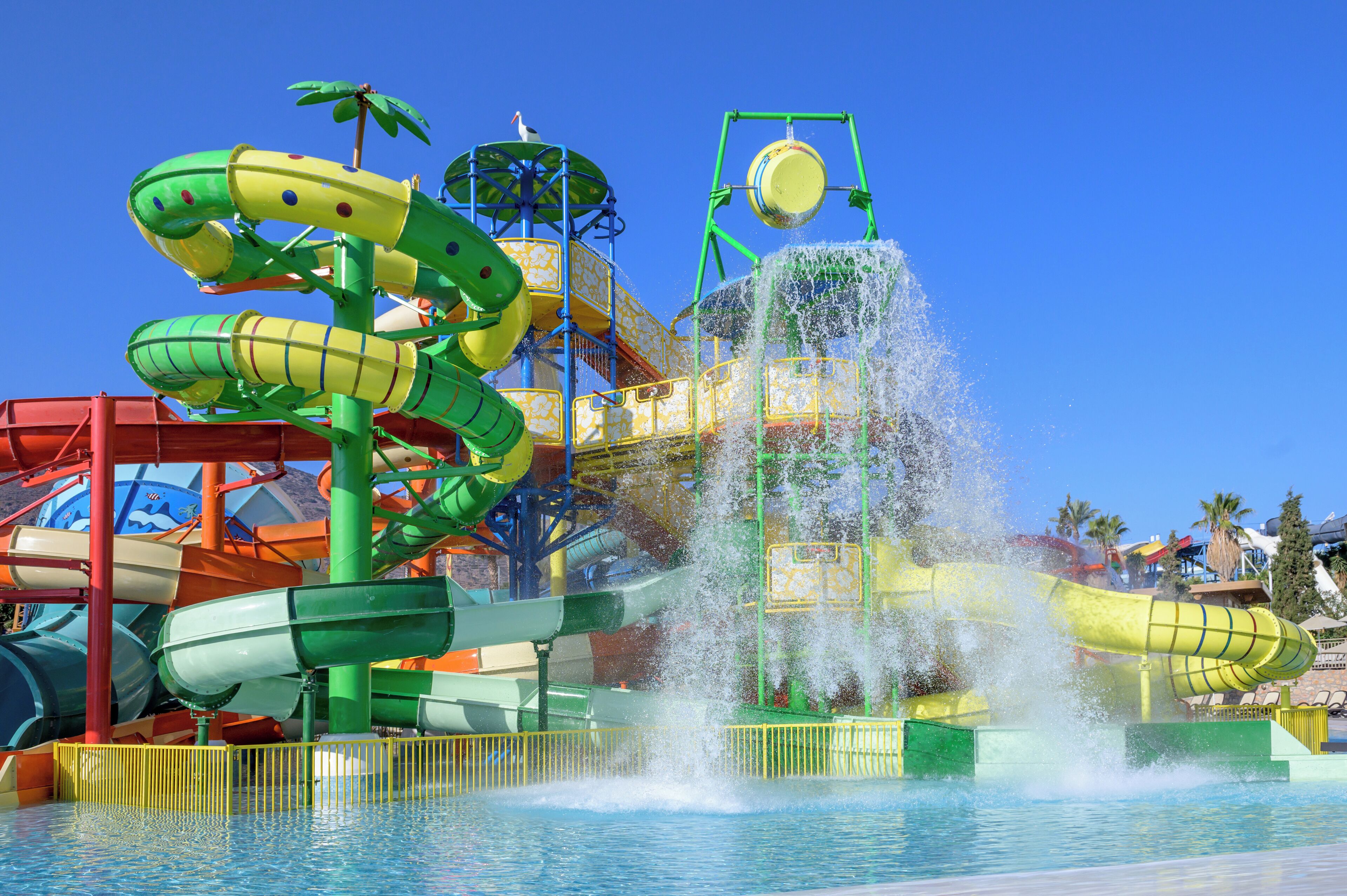A water park with multiple slides and a large water fountain.