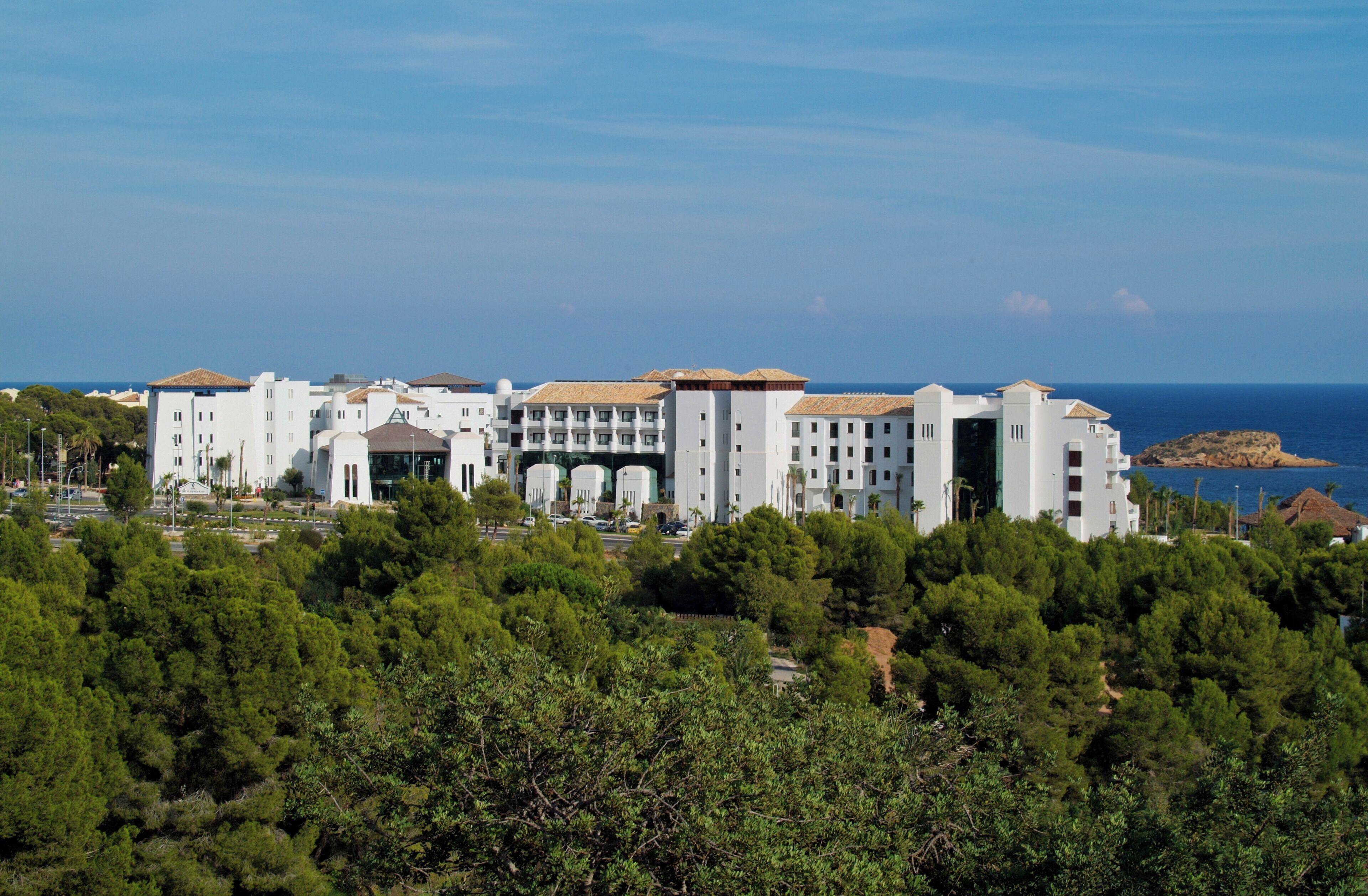 A large, multi-story hotel with a modern architectural style, featuring a prominent entrance and multiple balconies.