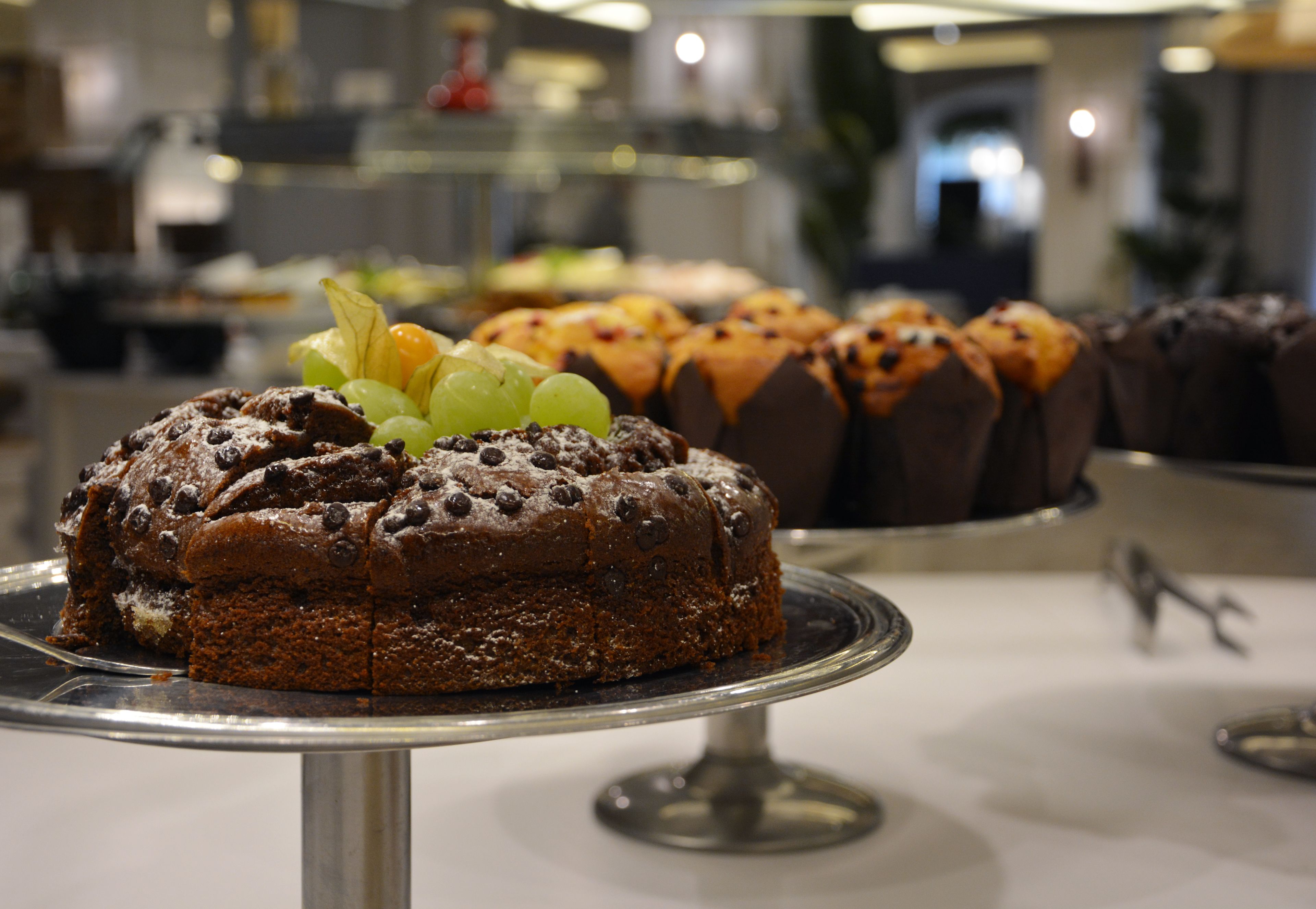 A dessert display with various cakes and pastries.