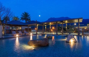 A pool area with lounge chairs, a covered seating area, and a mountain backdrop. - Yangmingshan Tien Lai Resort & Spa (New Taipei City)