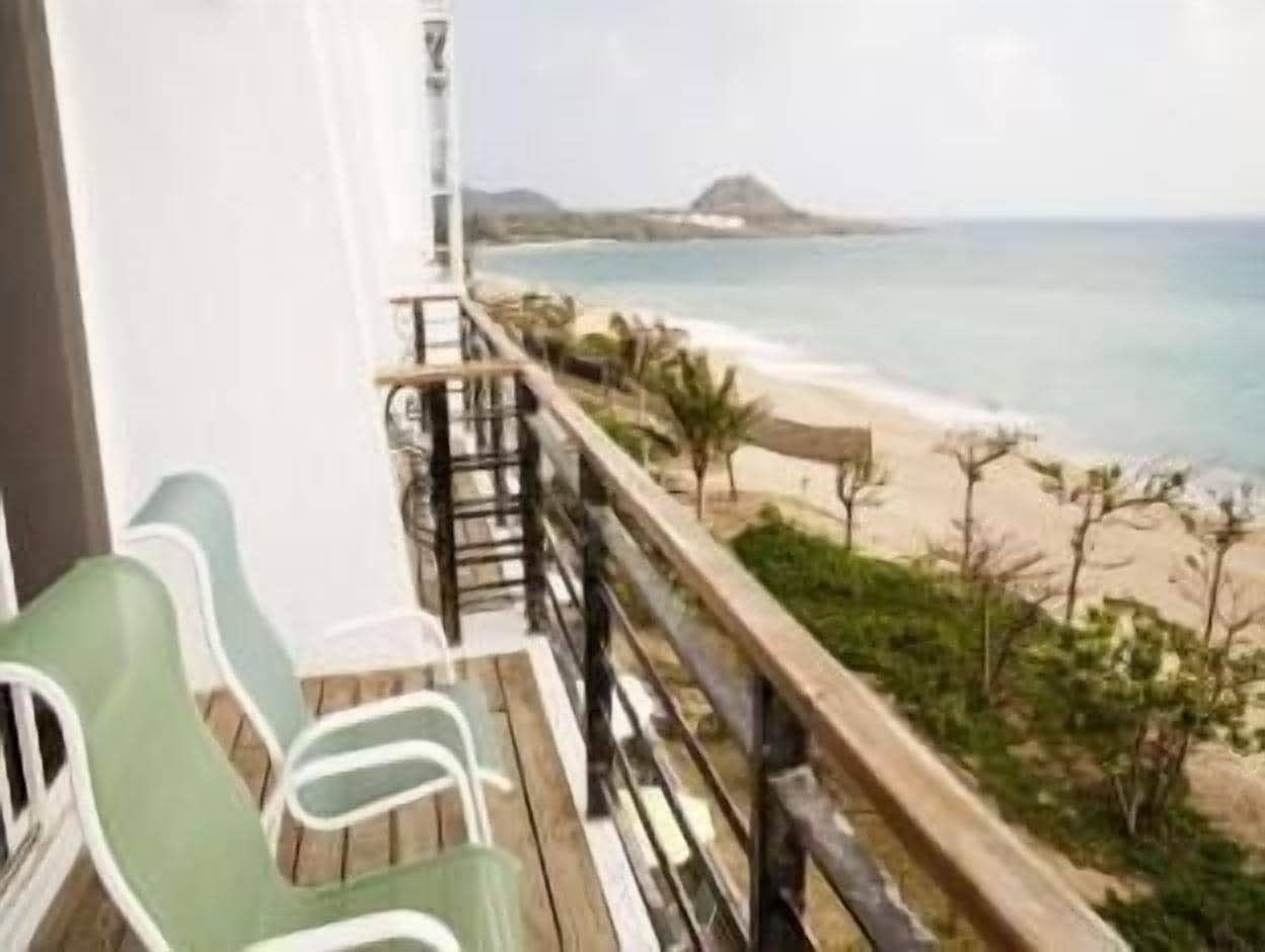 Un balcón con vista a la playa y al océano.