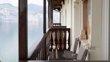 A balcony with a view of a lake and mountains.
