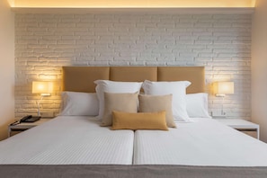 A neatly made bed with a headboard, two bedside lamps, and a nightstand with a phone. - Aluasoul Orotava Valley (Puerto de la Cruz)