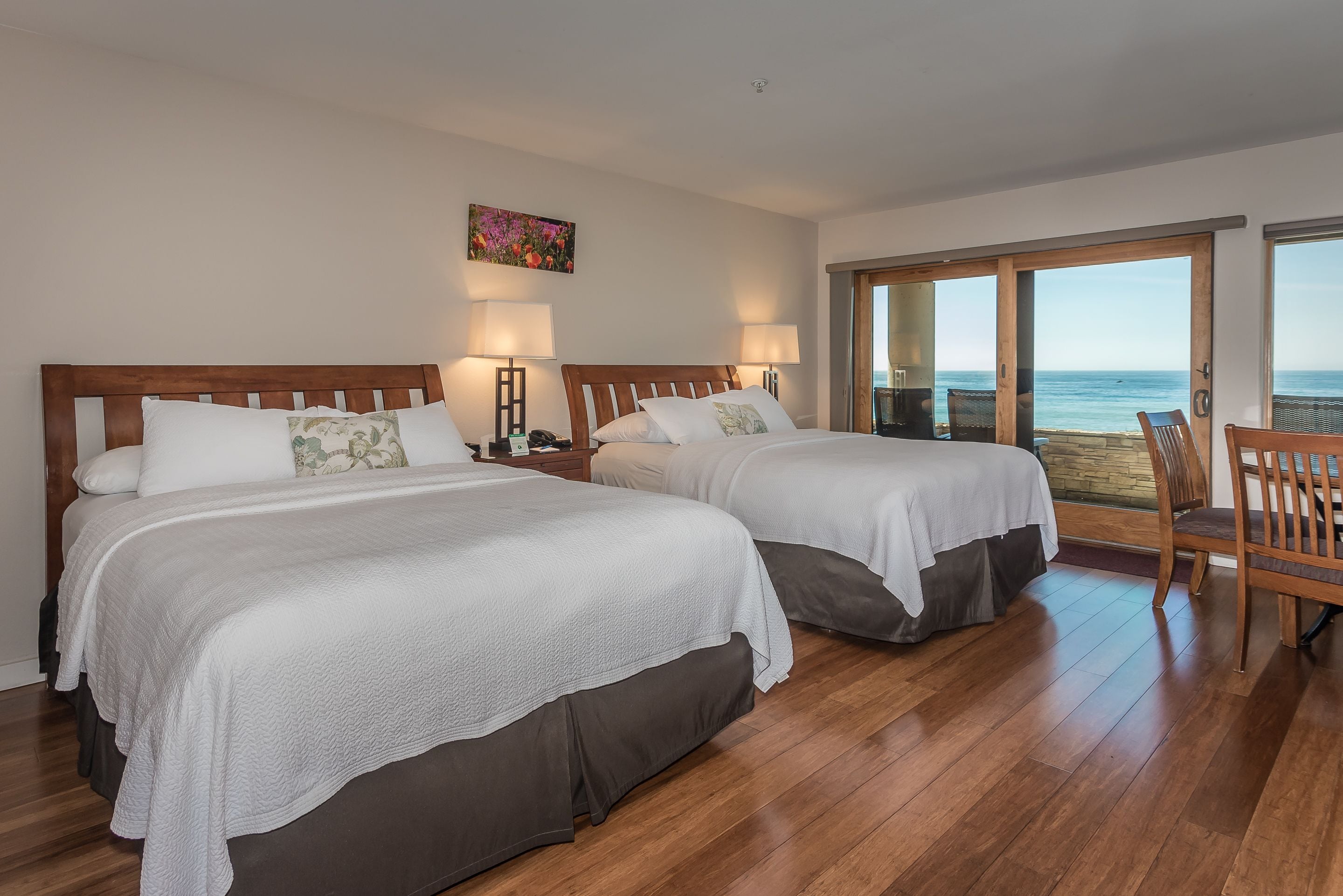 deluxe room, 2 queen beds, patio, ocean view | iron/ironing board, free cots/infant beds, free wifi, bed sheets