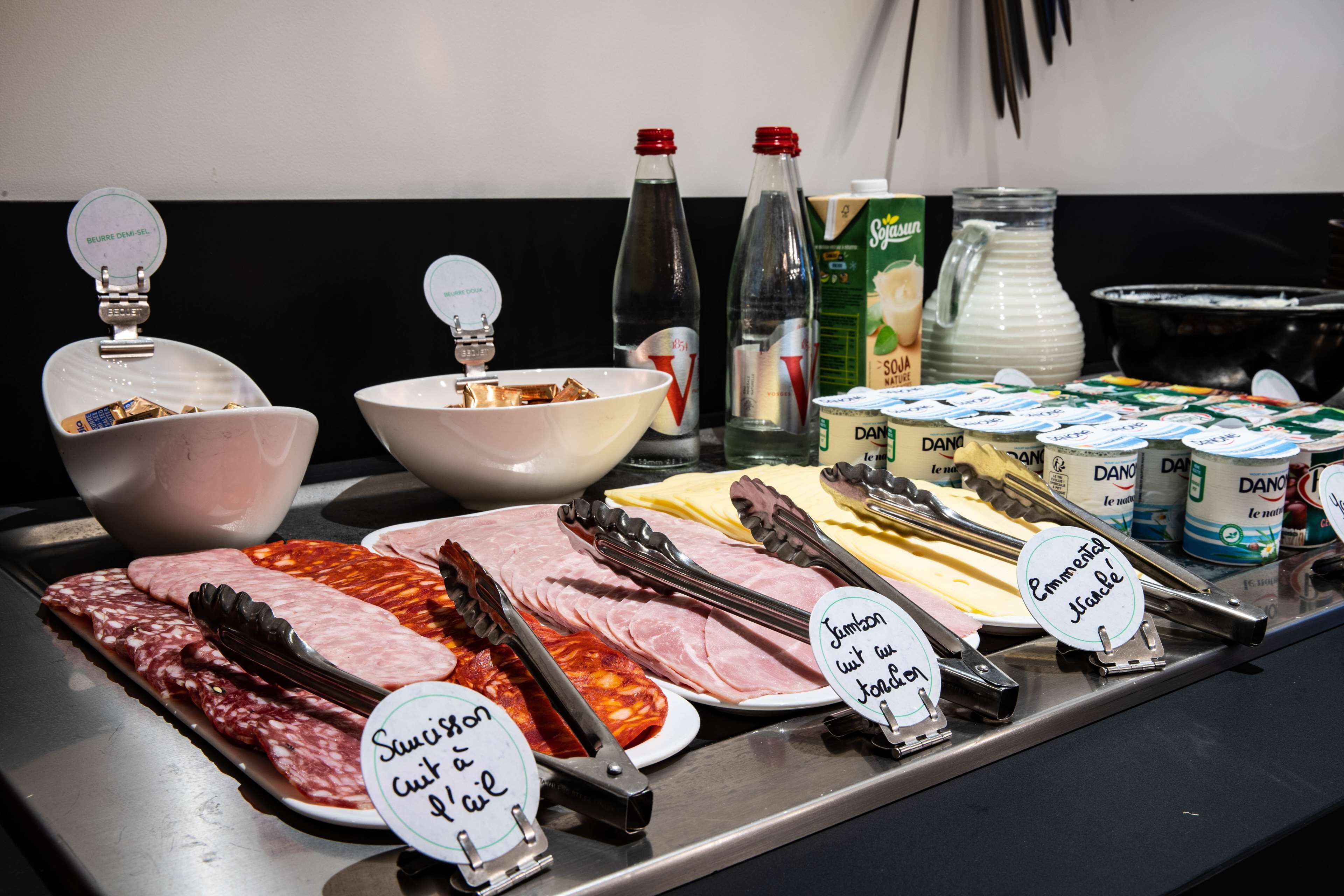 A buffet with various food items and condiments.