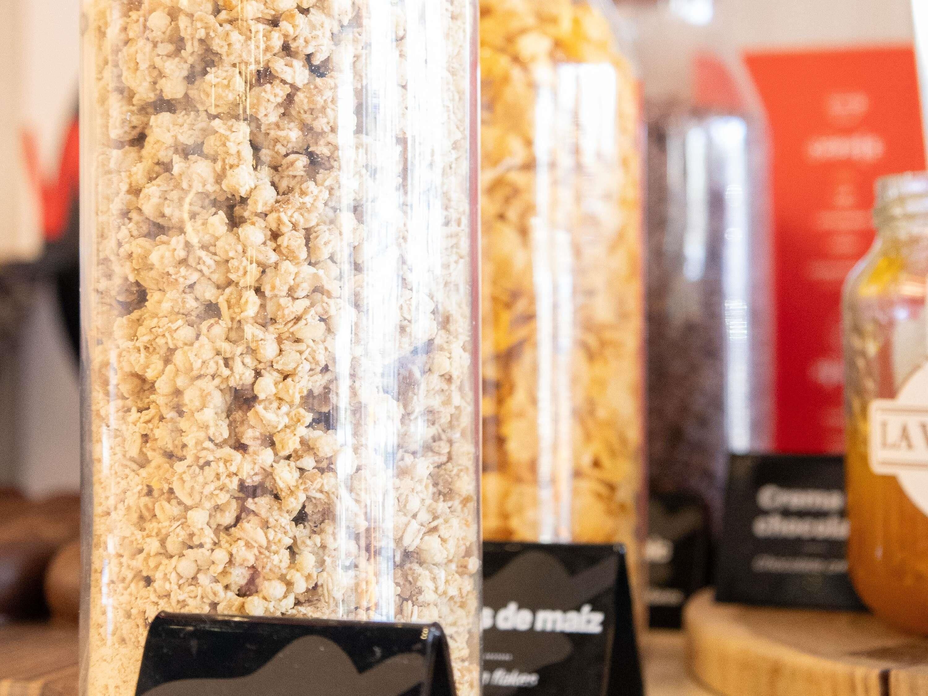 A display of granola bars in a transparent container.