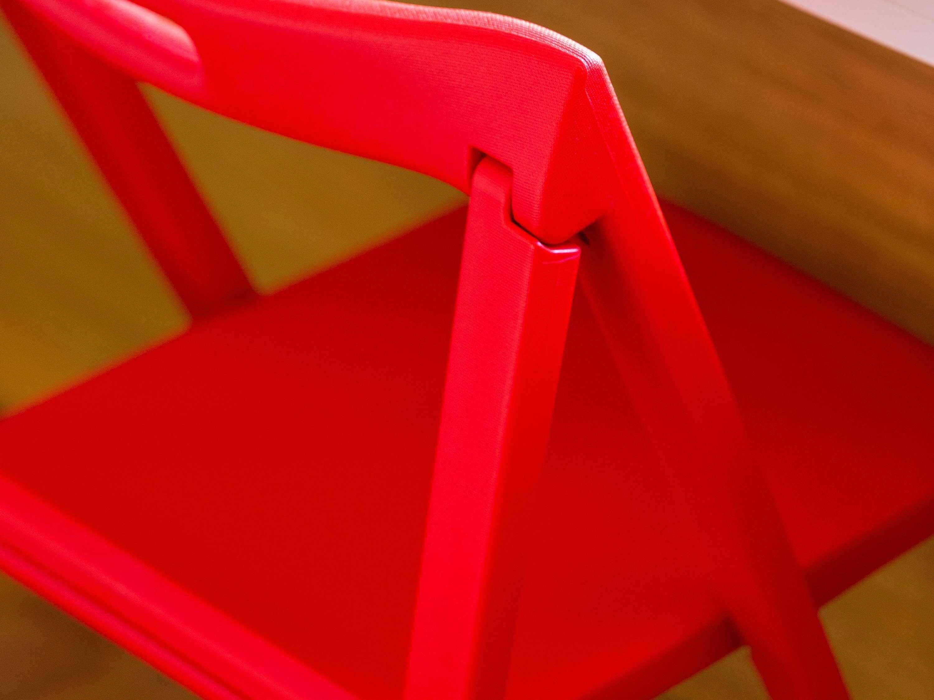 A close-up of a red chair with a visible seat and backrest.