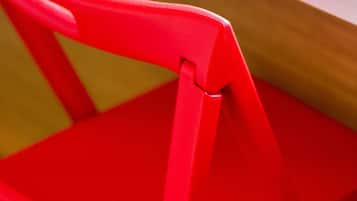A close-up of a red chair with a visible seat and backrest.