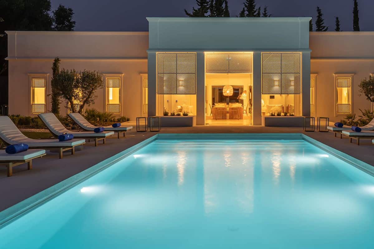 A modern poolside area with lounge chairs and a pool.