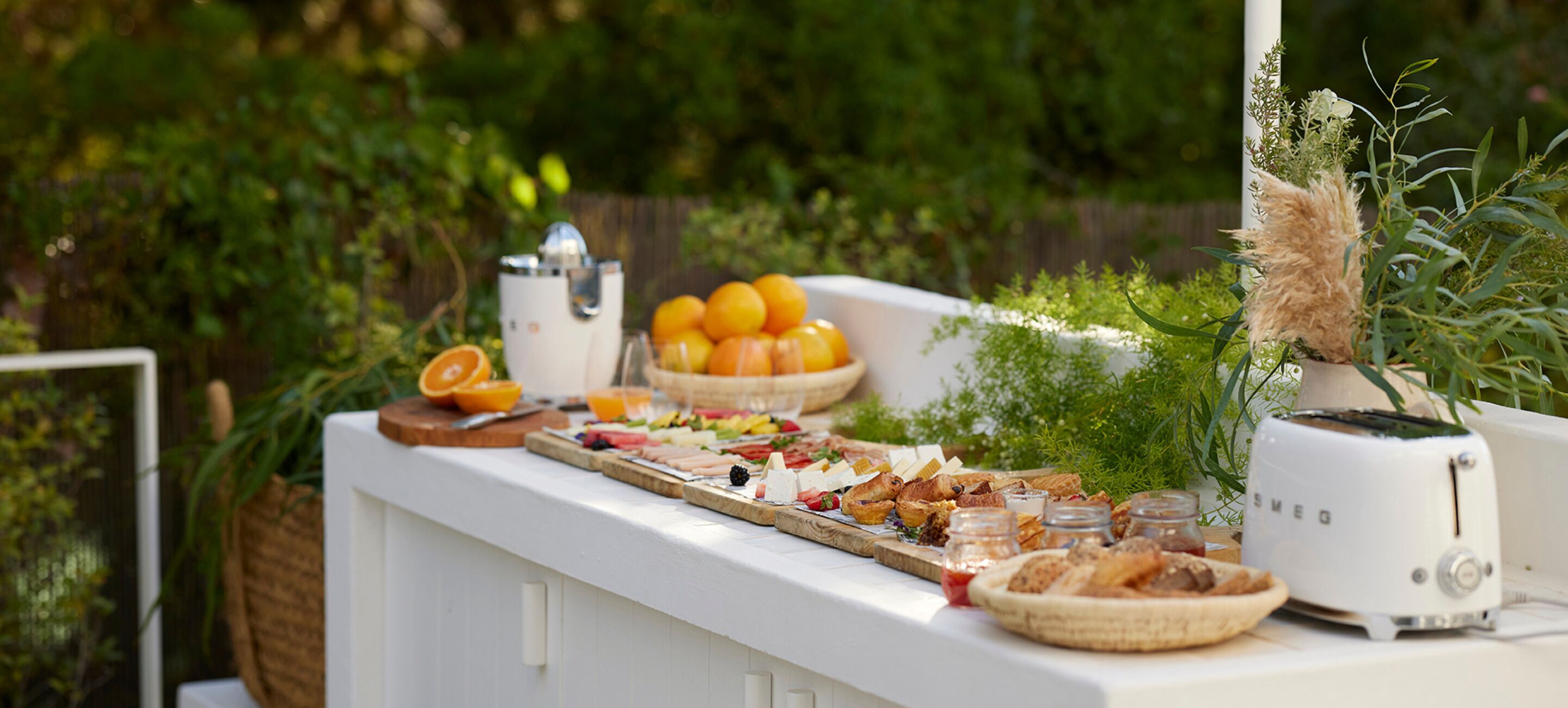 Una mesa de buffet con diferentes alimentos y un exprimidor de jugos.