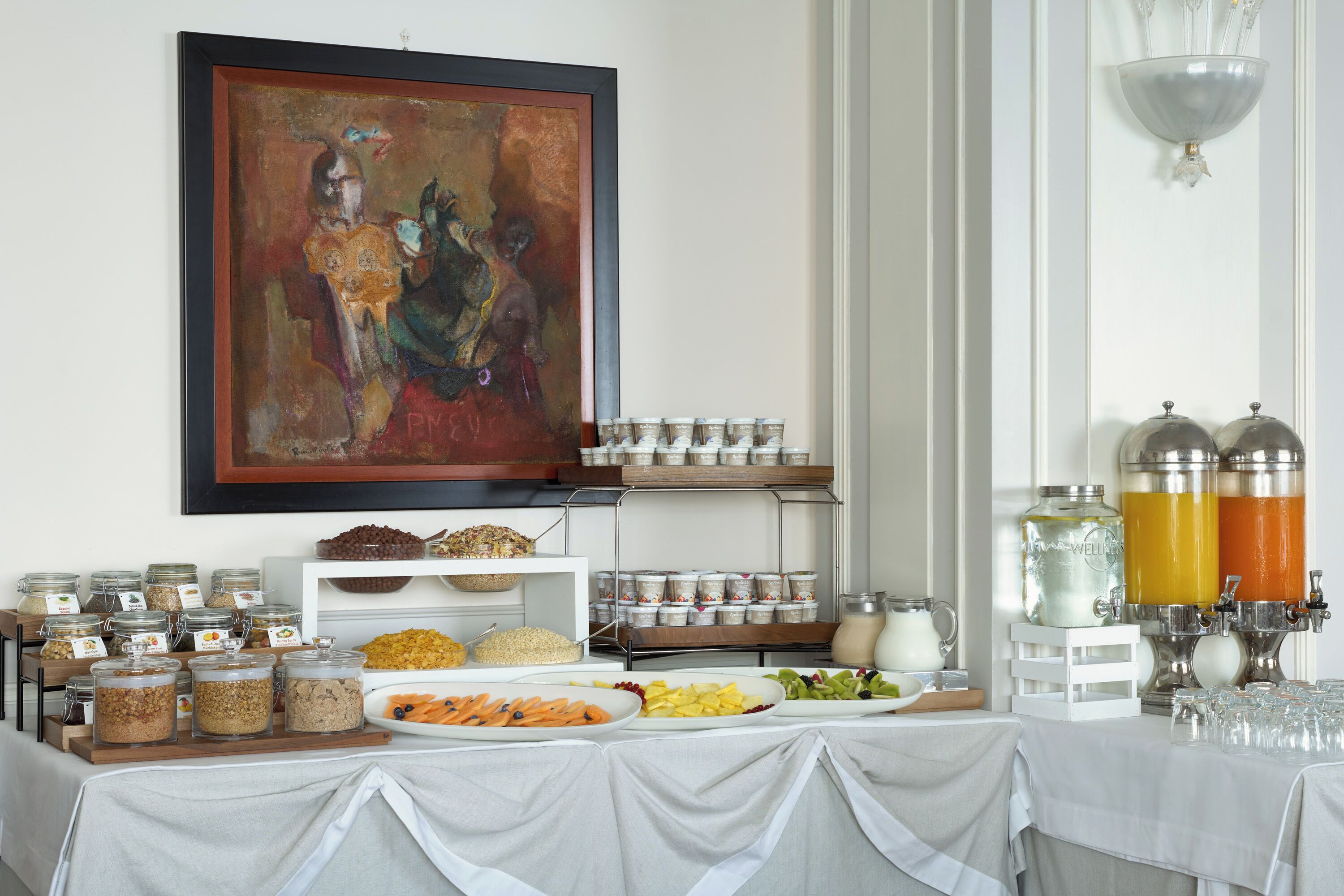 A buffet setup with various food items and beverages.