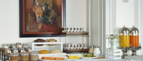 A buffet setup with various food items and beverages.