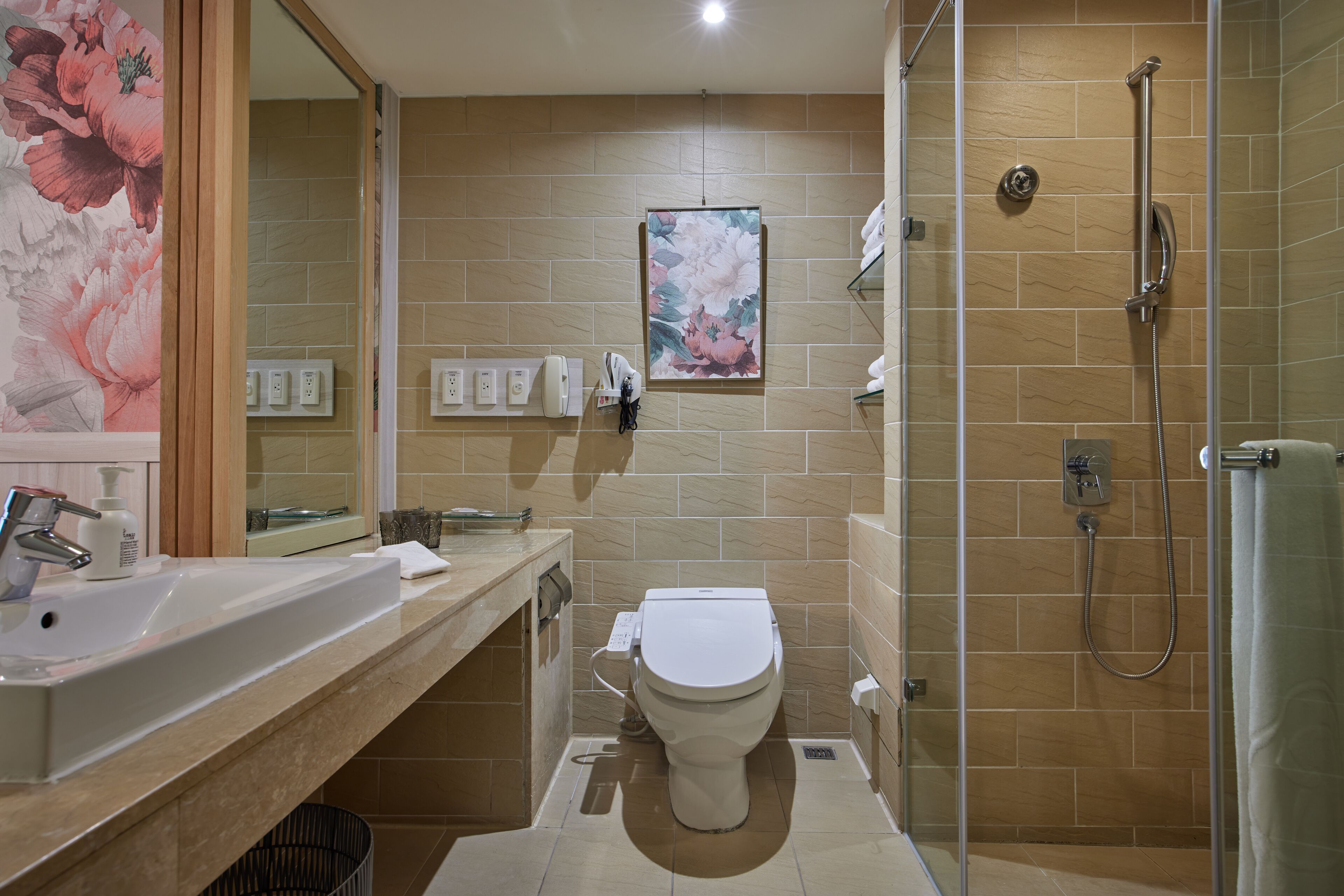 A bathroom with a sink, toilet, and shower.