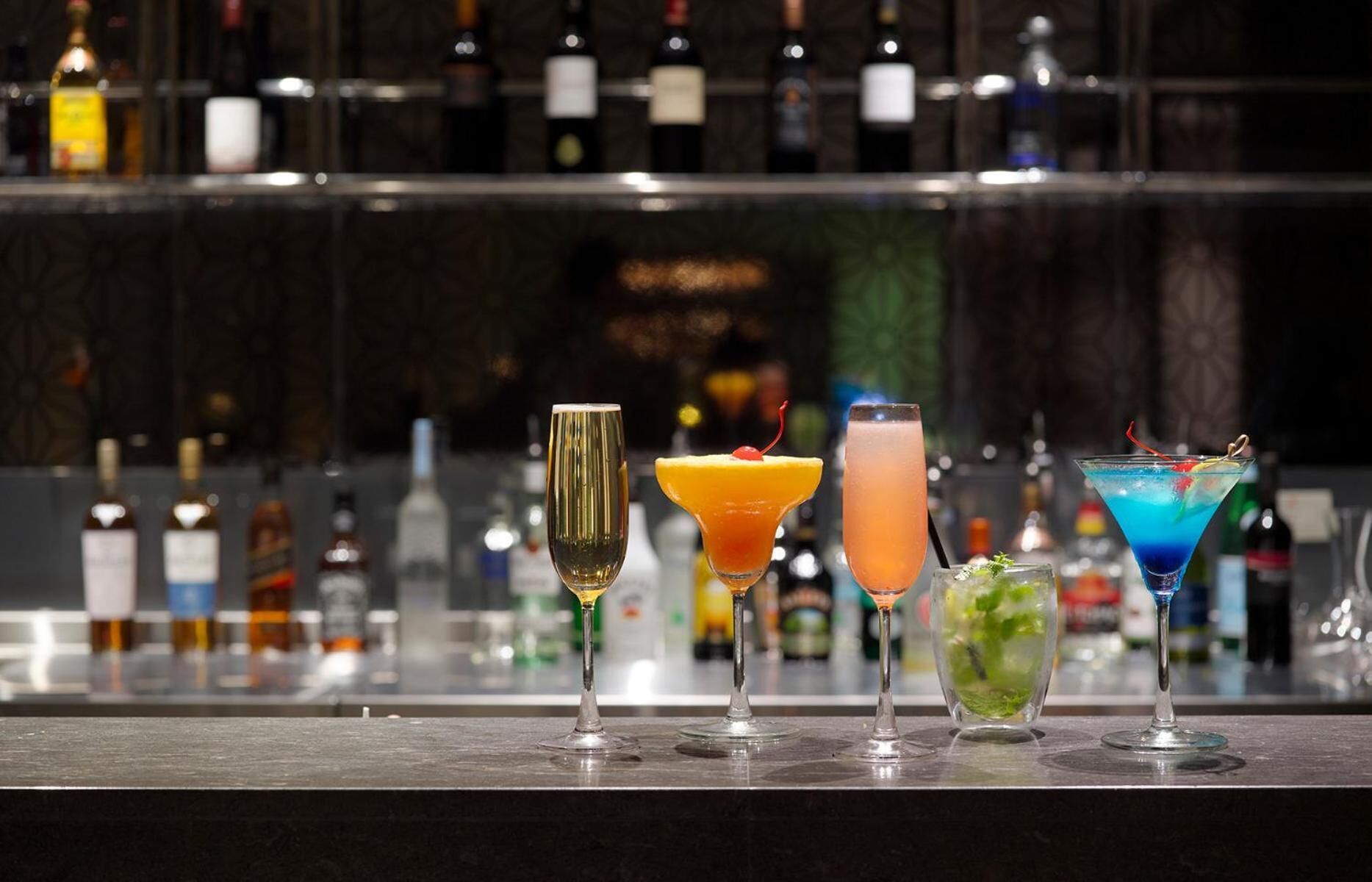A bar with four different cocktails.