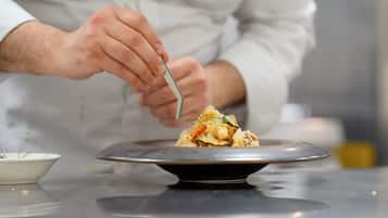 A person serving food from a bowl onto a plate.