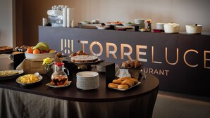 A buffet table with various food items and a sign reading 'TORRELUCENT'. - Cappuccina Country Resort (San Gimignano)