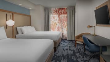 Premium bedding, desk, laptop workspace, blackout drapes