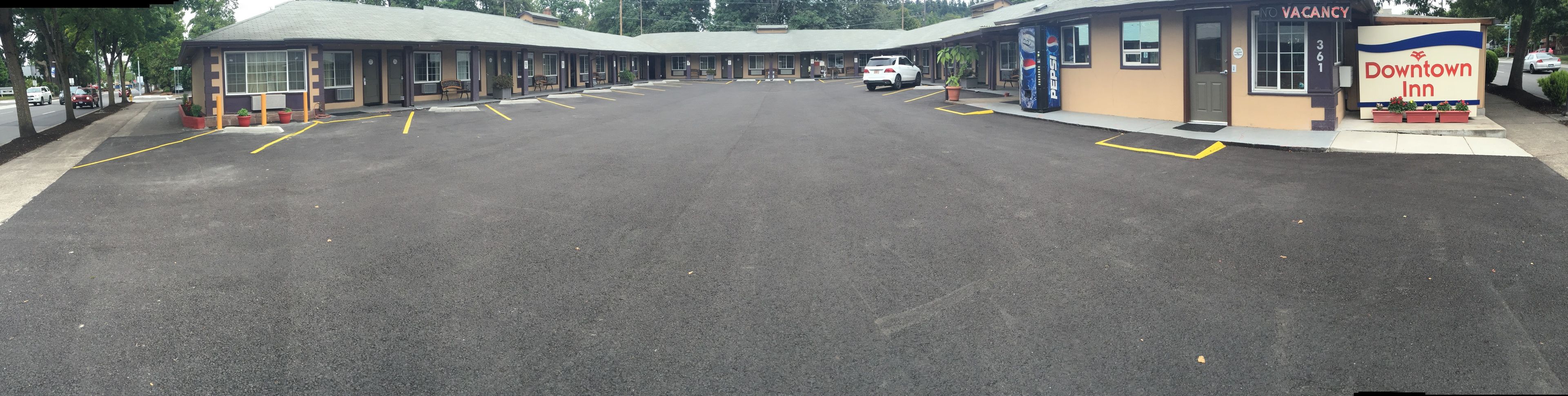 A motel with a parking lot, a Pepsi vending machine, and a sign indicating no vacancy.