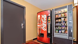 A vending machine with snacks and a Coca-Cola dispenser.